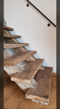 a set of stairs made out of wooden planks on top of a hard wood floor