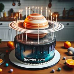 there is a cake with candles in the shape of saturn on top and an orange slice next to it