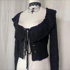 a mannequin wearing a black jacket and choker