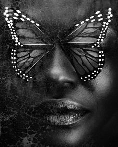 a woman's face with a butterfly painted on her face and the image is black and white