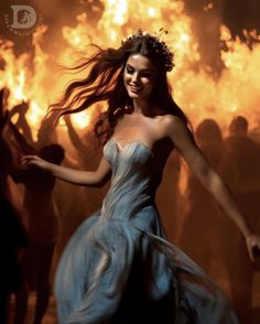 a woman in a dress is dancing with fire behind her