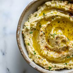 a bowl filled with mashed potatoes topped with mustard