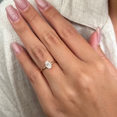 a woman's hand with a diamond ring on it