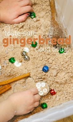 a child is playing with ginger bread in the sand