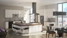 a kitchen with white cabinets and an island in the middle, surrounded by black chairs