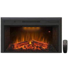 an electric fireplace with the remote control on it's side and fire logs in front