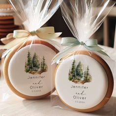 two cookies wrapped in clear cellophane and tied with ribbon are sitting on a table