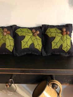 three decorative pillows are sitting on a shelf