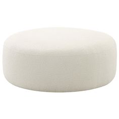 a white round ottoman sitting on top of a white flooring material covered in foam