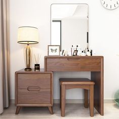 a wooden vanity with two stools next to it and a clock on the wall