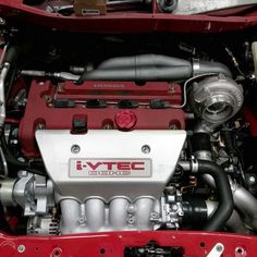 the engine compartment of a red sports car