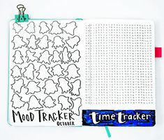 an open notebook with the words mood tracker and time trackerr written in black on it