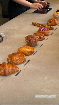 croissants are lined up on the counter to be sold