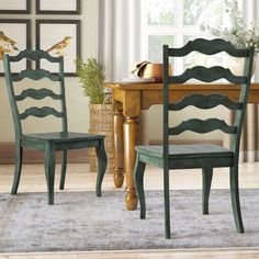 two green chairs sitting next to each other on top of a wooden dining room table