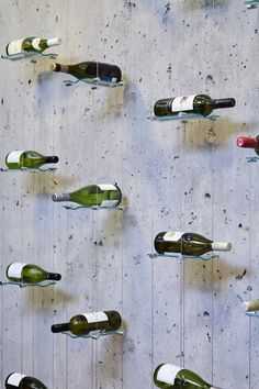 several wine bottles are hanging on the wall