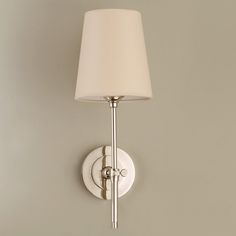 a wall light with a white shade on it