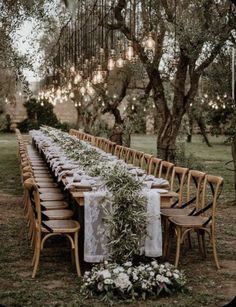 a long table set up for an outdoor dinner