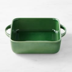 a green rectangular dish on a white surface