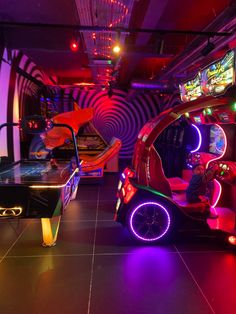 an arcade car is lit up with neon lights