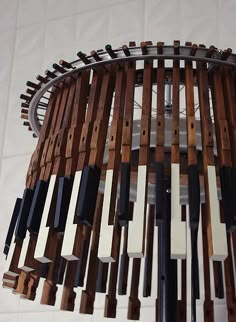 a chandelier made out of wooden pieces and metal bars hanging from the ceiling