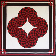 a red and black quilt with four circles on it