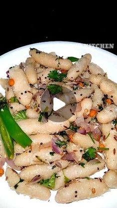 a white plate topped with pasta and veggies