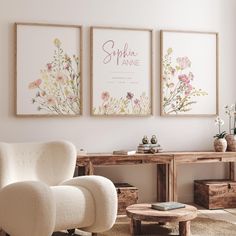 two framed art prints on the wall above a chair and table in a living room