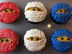 six cupcakes with different colored frosting on them, each decorated like an individual's face