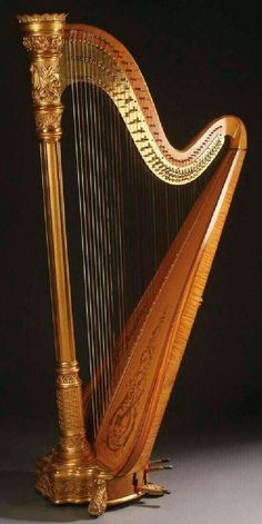 an ornate golden harp on a black background with the strings still attached to it's sides