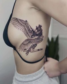 a woman with a bird tattoo on her stomach