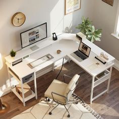 an overhead view of a desk with a laptop and desktop computer on it, in front of a window