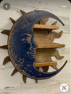 the sun and moon face is made out of wood, with shelves on each side