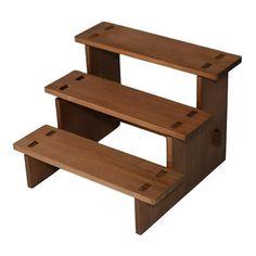 three tiered wooden step stool with holes in the bottom and lower section, on an isolated white background