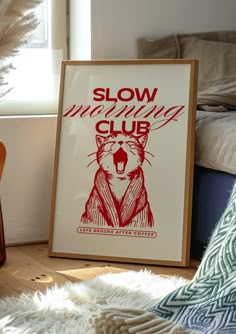 a framed poster sitting on top of a wooden floor next to a guitar and pillow