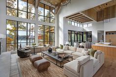 a living room filled with furniture and large windows