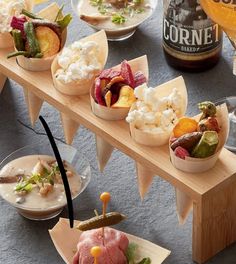 a table topped with bowls filled with different types of food and drinks next to each other