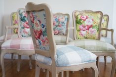 four chairs with floral upholstered back and seat cushions in various colors, sizes and styles