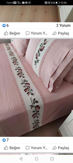 the bed is made with pink sheets and pillows on top of it, along with matching pillow cases