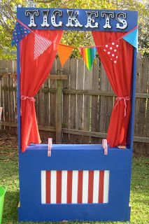 an outdoor ticket booth with red, white and blue curtains