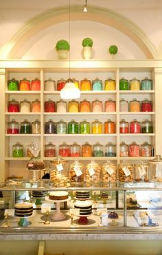 a display case filled with lots of cakes and desserts