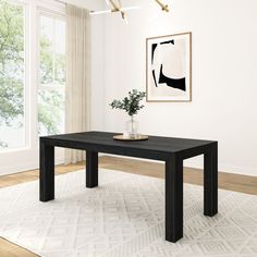 a black table sitting on top of a white rug