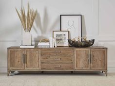 a wooden sideboard with drawers and pictures on it