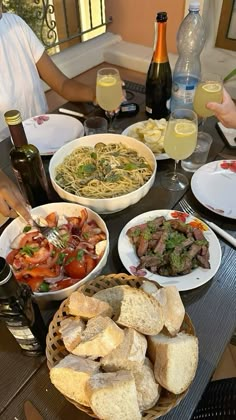 people sitting at a table full of food and drinks