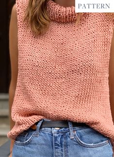 a woman wearing a pink sweater and jeans