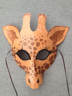 a giraffe mask that is on the ground