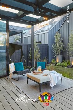 an outdoor living area with patio furniture and lighting on the ceiling is decorated in teal blue