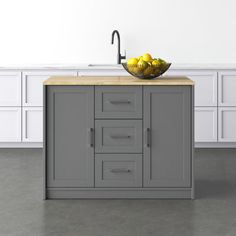 a bowl of lemons sitting on top of a kitchen island