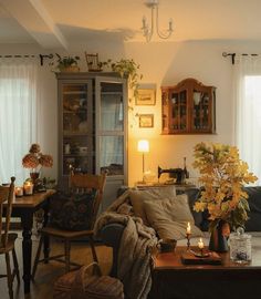 a living room filled with furniture and lots of flowers on top of a wooden table