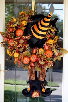 a halloween wreath hanging on the front door