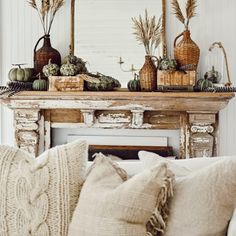 a living room filled with lots of furniture and decor on top of a fire place